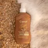 Carrot Sun Gold Ex – 200ml Natural Tanning Spray Carrot Gold Ex Tanning Spray – 200ml tanning oil bottle on sand
