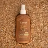 Carrot Sun Gold Ex – 200ml Natural Tanning Spray Carrot Gold Ex Tanning Spray – 200ml tanning oil bottle on sand