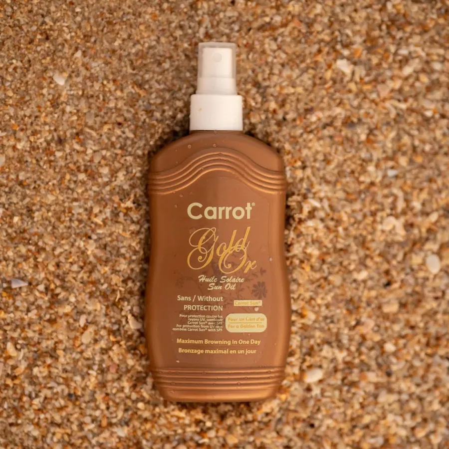 Carrot Sun Gold Ex – 200ml Natural Tanning Spray Carrot Gold Ex Tanning Spray – 200ml tanning oil bottle on sand